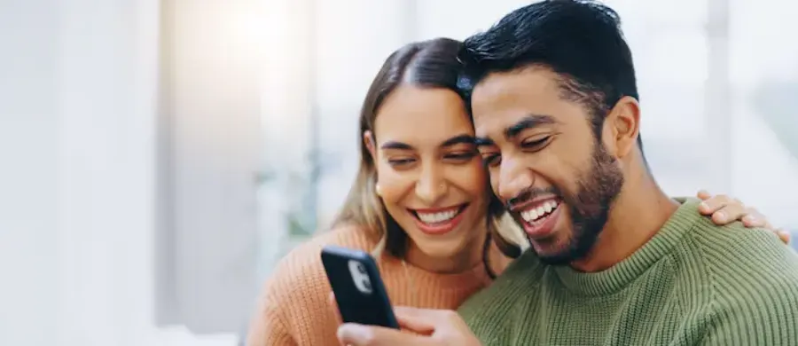 Couple smiling at a phone